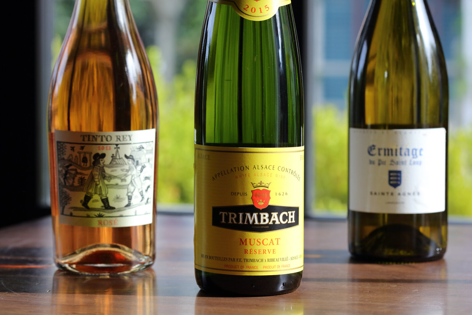 Three wine bottles — Tinto Rey, Trimbach, Ermitage
